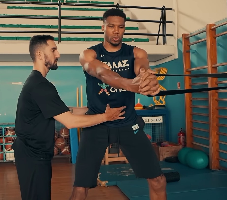 Georgios coaching Antetokounmpo during a resistance-band training session