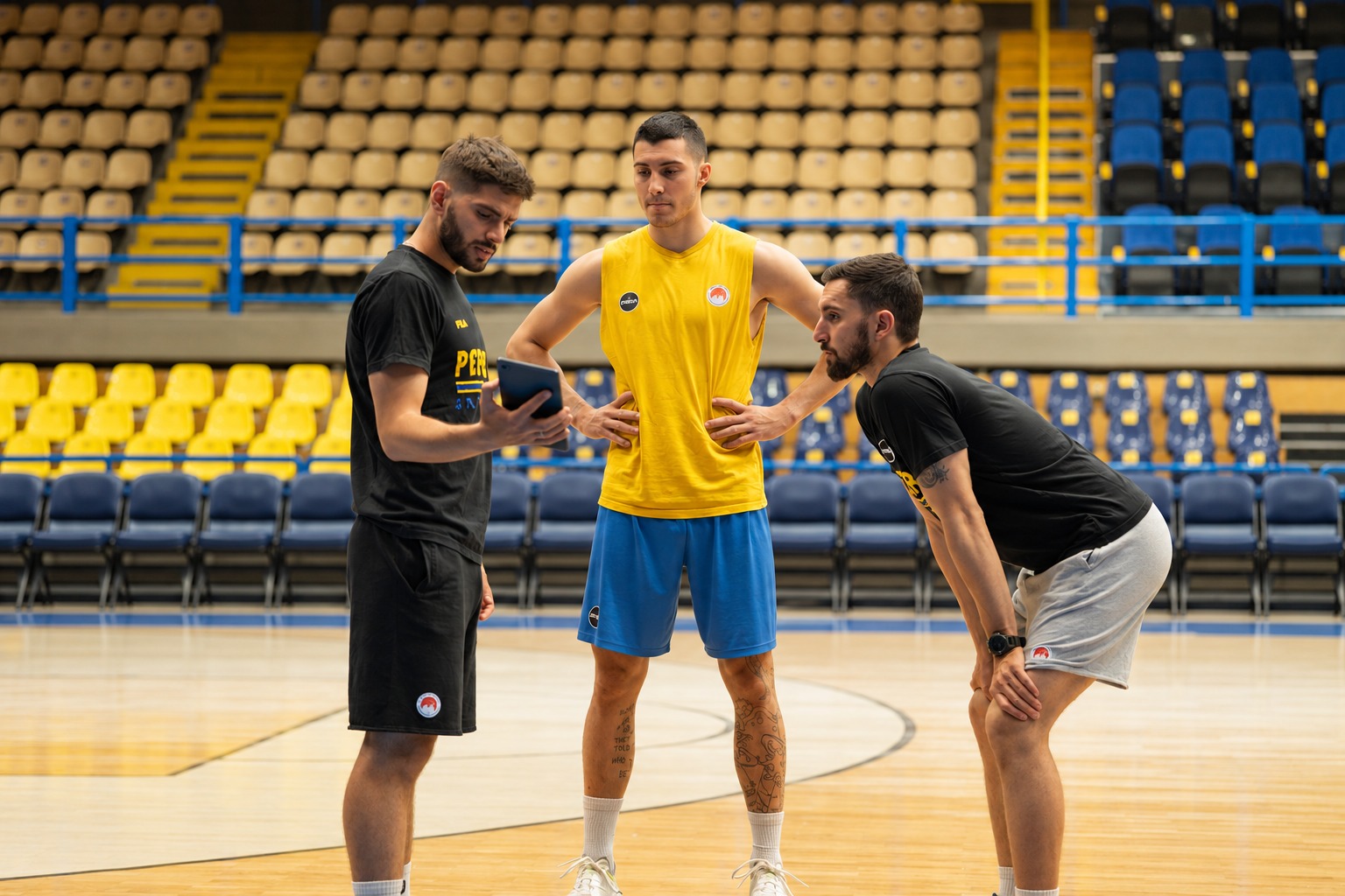 Georgios and Kosmas working with a basketball athlete on court